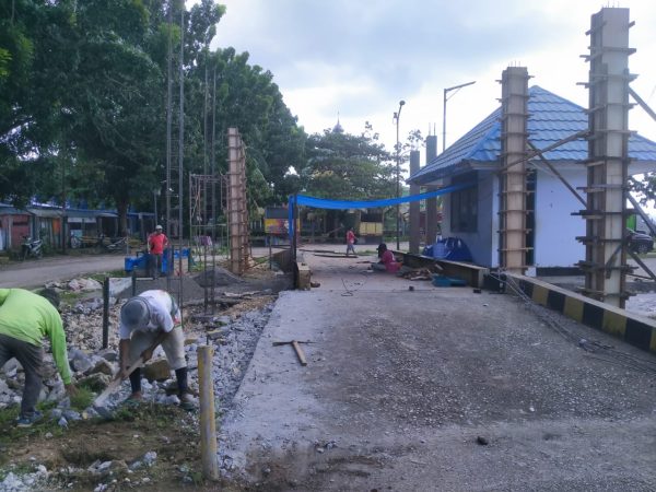 Para pekerja terlihat sedang mengerjakan proyek rehabilitasi jembatan timbang pelabuhan feri Batulo, Rabu (6/6). Pengerjaannya sudah berlangsung sekira satu pekan, namun tidak dipasangi papan proyek. (Foto: Texandi)