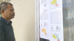 Ketua KPU Kota Baubau, Edi Sabara menunjukkan pengumuman tiga opsi rancangan penataan Dapil dan alokasi kursi DPRD untuk digunakan pada Pemilu 2024. Dua rancangan diketahui merupakan format baru. (Foto Texandi)